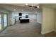 Open-concept kitchen with stainless steel appliances, white cabinets, and a large center island at 3924 Orchard Hill Cir, Palm Harbor, FL 34684