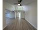 Spacious living room featuring sleek floors, a modern ceiling fan, and ample natural light at 3924 Orchard Hill Cir, Palm Harbor, FL 34684