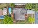 An aerial view of the home showing the roof, pool, landscaping, and surrounding neighborhood at 4010 Lithia Ridge Blvd, Valrico, FL 33596