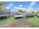 A spacious backyard featuring a trampoline, deck, and above ground pool perfect for outdoor fun at 4010 Lithia Ridge Blvd, Valrico, FL 33596