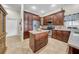 Modern kitchen with updated appliances, stone countertops, dark wood cabinets, and a kitchen island at 4010 Lithia Ridge Blvd, Valrico, FL 33596