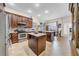 Open kitchen with stainless steel appliances, an island, and a dining area overlooking the backyard at 4010 Lithia Ridge Blvd, Valrico, FL 33596