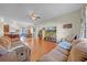 Open-concept living room with hardwood flooring, connecting to kitchen and dining area at 4010 Lithia Ridge Blvd, Valrico, FL 33596