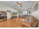 Spacious living room featuring wood-look tile flooring and a ceiling fan at 4010 Lithia Ridge Blvd, Valrico, FL 33596