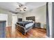 Large main bedroom featuring hardwood floors, ceiling fan, and en-suite bath at 4010 Lithia Ridge Blvd, Valrico, FL 33596