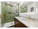Bathroom featuring double sinks, marble countertops, and a glass-enclosed shower at 429 88Th Ave, St Pete Beach, FL 33706