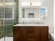 Bathroom featuring double sinks, sleek wood cabinetry, and tiled shower at 429 88Th Ave, St Pete Beach, FL 33706