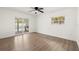 Bright bedroom boasts wood floors, ceiling fan, and sliding doors to the outdoor kitchen at 429 88Th Ave, St Pete Beach, FL 33706