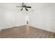 Bedroom with wood floors, ceiling fan, closet, and adjacent bathroom at 429 88Th Ave, St Pete Beach, FL 33706