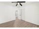 This bright bedroom boasts a ceiling fan, wood floors, and an adjacent closet and hallway at 429 88Th Ave, St Pete Beach, FL 33706