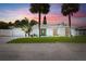 Charming single-story home with a well-manicured lawn, palm trees, and a decorative front door at 429 88Th Ave, St Pete Beach, FL 33706