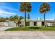 Charming single-story home with a well-manicured lawn, palm trees, and a decorative front door at 429 88Th Ave, St Pete Beach, FL 33706