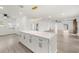 Open-concept kitchen and living room area featuring stainless appliances, an oversized island, and modern fixtures at 429 88Th Ave, St Pete Beach, FL 33706