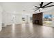 Bright, open living room with fireplace, ceiling fan, fresh paint, and new floors for a clean, modern look at 429 88Th Ave, St Pete Beach, FL 33706