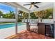 Outdoor kitchen area with grill and mini-fridge located on screened-in patio at 429 88Th Ave, St Pete Beach, FL 33706