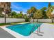 Backyard swimming pool surrounded by lush, tropical landscaping and a white vinyl privacy fence at 429 88Th Ave, St Pete Beach, FL 33706