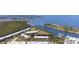 Scenic aerial view of waterfront condos nestled near a lush green area and beautiful blue ocean inlet at 456 Bahia Beach Blvd, Ruskin, FL 33570