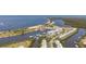 Stunning aerial view of waterfront community with a marina, beach, and condos, blending coastal living with modern amenities at 456 Bahia Beach Blvd, Ruskin, FL 33570