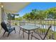 Private balcony seating area with a scenic view of the water and lush greenery at 456 Bahia Beach Blvd, Ruskin, FL 33570
