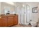 Bright bathroom showcasing a glass shower, granite countertops, and wooden vanity with modern fixtures at 456 Bahia Beach Blvd, Ruskin, FL 33570