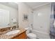 Clean bathroom featuring a shower-tub combo with a white tile surround and granite sink vanity at 456 Bahia Beach Blvd, Ruskin, FL 33570