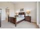 Elegant bedroom features a wooden bed frame and matching nightstands with soft, neutral carpeting at 456 Bahia Beach Blvd, Ruskin, FL 33570