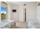 Inviting bedroom with balcony access features twin beds, a mounted tv, and closet at 456 Bahia Beach Blvd, Ruskin, FL 33570