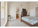 Bright bedroom featuring a comfortable bed, dresser, and access to the balcony at 456 Bahia Beach Blvd, Ruskin, FL 33570