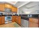 Modern kitchen featuring stainless steel appliances, granite countertops, and wooden cabinetry at 456 Bahia Beach Blvd, Ruskin, FL 33570