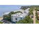 An aerial view shows white waterfront condos featuring incredible views, mature trees, and surrounding landscapes at 4950 Bayshore Blvd # 27, Tampa, FL 33611