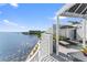 Relaxing outdoor condo terrace with covered seating, bay views, and lush potted plants at 4950 Bayshore Blvd # 27, Tampa, FL 33611