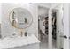 Stylish bathroom featuring marble countertop, herringbone accent wall and access to closet at 4950 Bayshore Blvd # 27, Tampa, FL 33611