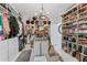 Spacious walk-in closet with custom shelving, chandelier, and center island at 4950 Bayshore Blvd # 27, Tampa, FL 33611