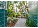 Inviting courtyard with tables, seating, lush foliage, and unique exterior finishes on a sunny day at 4950 Bayshore Blvd # 27, Tampa, FL 33611