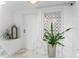Bright hallway with white walls, frosted glass window and stylish decor accents at 4950 Bayshore Blvd # 27, Tampa, FL 33611