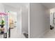 Light and airy hallway with marble floors leads to a bright bedroom, showcasing a modern interior at 4950 Bayshore Blvd # 27, Tampa, FL 33611