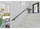 Bright staircase with marble steps, black railing and natural light at 4950 Bayshore Blvd # 27, Tampa, FL 33611