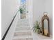 Elegant staircase with marble steps and black railing leading upwards at 4950 Bayshore Blvd # 27, Tampa, FL 33611