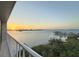 Balcony view of the sunset over the water, trees, and a town with docks at 500 N Osceola Ave # 808, Clearwater, FL 33755