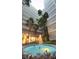 Outdoor common area with a circular fountain surrounded by tropical landscaping and tall condo buildings at 500 N Osceola Ave # 808, Clearwater, FL 33755