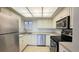 Well-lit kitchen featuring stainless steel appliances and white cabinets at 500 N Osceola Ave # 808, Clearwater, FL 33755
