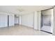 Bright, empty living room with tile floors, a ceiling fan, and access to a balcony through sliding glass doors at 500 N Osceola Ave # 808, Clearwater, FL 33755