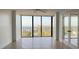 Spacious, bright, empty living room with tile floors and a balcony with large windows and doors at 500 N Osceola Ave # 808, Clearwater, FL 33755
