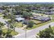 Aerial view of the property showcasing the fenced backyard, neighborhood, and mature trees at 5290 101St Ave, Pinellas Park, FL 33782