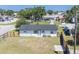 Spacious backyard featuring a well-maintained lawn, a privacy fence, and a view of the home's exterior at 5290 101St Ave, Pinellas Park, FL 33782