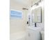 Bathroom features a sleek vanity and shower-tub combination with black hardware at 5290 101St Ave, Pinellas Park, FL 33782