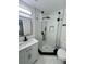 Renovated bathroom features a corner glass shower enclosure and modern fixtures at 5290 101St Ave, Pinellas Park, FL 33782