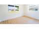 Bright bedroom with a large window and wood-look floors and white walls at 5290 101St N Ave, Pinellas Park, FL 33782