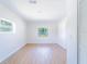 Empty bedroom with natural light from two windows and wood-look floors at 5290 101St Ave, Pinellas Park, FL 33782
