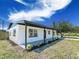 Exterior view of home featuring fresh landscaping and a covered front porch at 5290 101St Ave, Pinellas Park, FL 33782